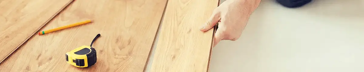 A professional installing wood flooring in Phoenix, AZ