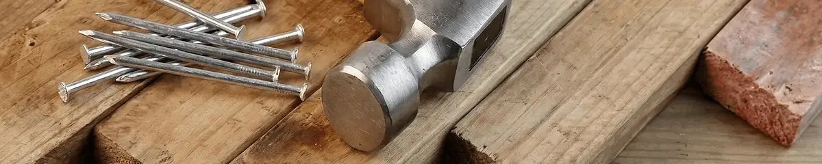 Hammer and nails on hardwood flooring boards in Phoenix, AZ