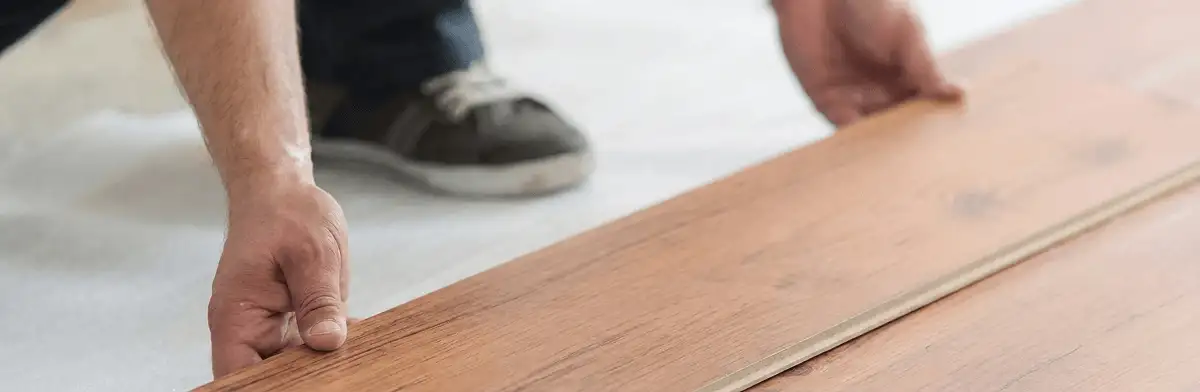A professional installing laminate flooring in Phoenix, AZ