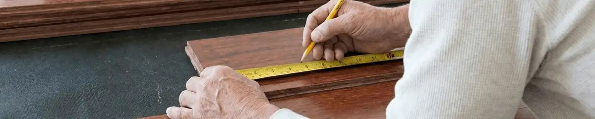 A professional installing wood flooring in Phoenix, AZ